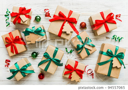 Colored craft gift boxes with colorful ribbons on colored background. Collection of Christmas present boxes Colored craft gift boxes with colorful ribbons on colored background. Collection of Christmas present boxes 94557065