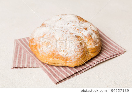 Assortment of freshly baked bread with napkin on rustic table top view. Healthy unleavened bread. French bread 94557189