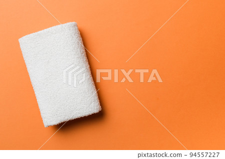 Top view of white towels with copy space on colored background 94557227