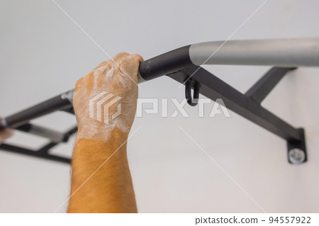 Fragment horizontal bar installed on the balcony of the apartment for sports when there is no time to visit the gym. Fragment horizontal bar installed on the balcony of the apartment for sports when there is no time to visit the gym. 94557922