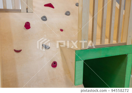 a public children's playground with a climbing house. 94558272