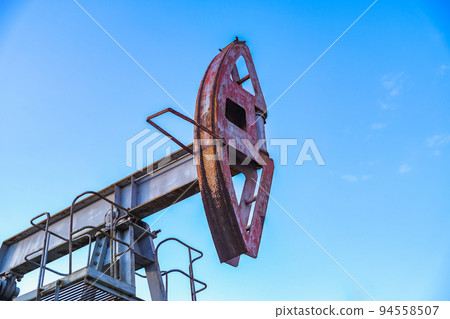 An abandoned oil or gas rocking machine against a 94558507