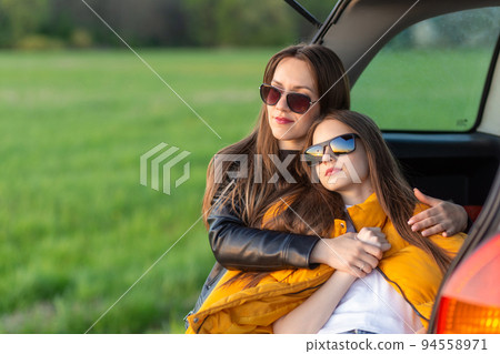 Mother and daughter camping on a hill 94558971