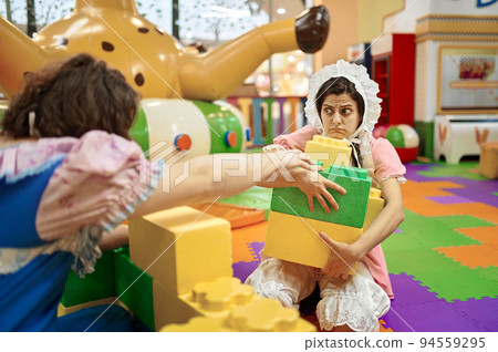 Funny man and woman like baby playing soft building blocks Funny man and woman like baby playing soft building blocks 94559295