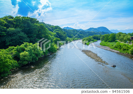 Scenery of the Tone River, Tanigawa mountain range, view upstream from Jizo Bridge, early summer season Scenery of the Tone River, Tanigawa mountain range, view upstream from Jizo Bridge, early summer season 94561506