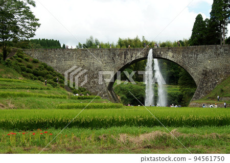 Landscape of Kumamoto's tourist attraction Tsujun Bridge when water is discharged 94561750