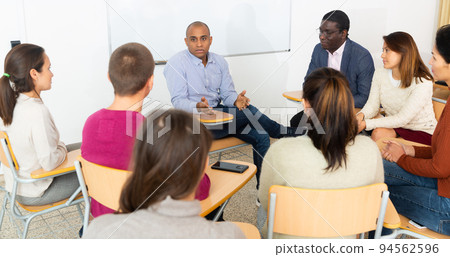 Multicultural people meeting in circle of chairs Multicultural people meeting in circle of chairs 94562596