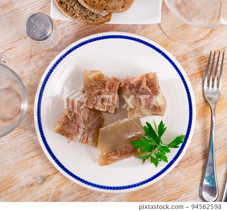 Kholodets served on table with parsley sprig 94562598