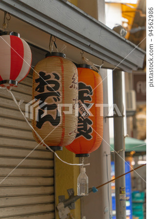Red lanterns hanging at the storefront of an izakaya Red lanterns hanging at the storefront of an izakaya 94562986