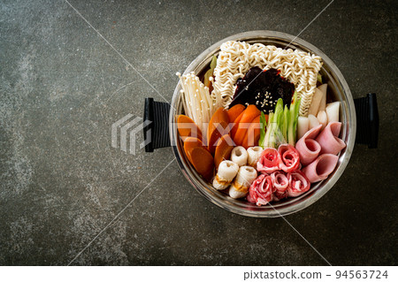 Budae Jjigae or Budaejjigae (Army stew or Army base stew). It is loaded with Kimchi, spam, sausages, ramen noodles and much more 94563724