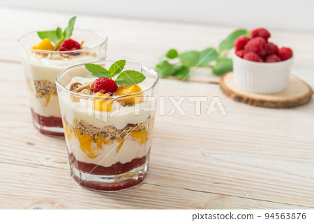 homemade mango and raspberry with yogurt and granola homemade mango and raspberry with yogurt and granola 94563876
