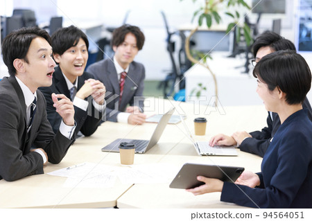 Sales person giving a presentation with a surprised businessman_1 Sales person giving a presentation with a surprised businessman_1 94564051