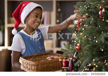 Happy cute African American kid in red Santa cap Happy cute African American kid in red Santa cap 94566800