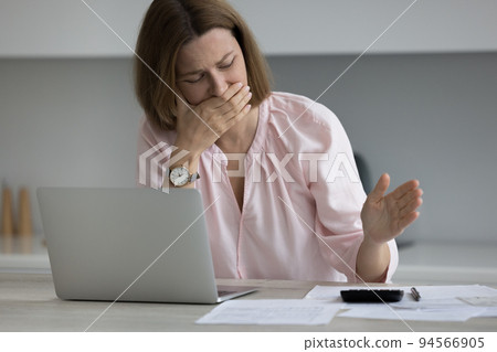 Frustrated broke business woman, entrepreneur, homeowner crying over calculator Frustrated broke business woman, entrepreneur, homeowner crying over calculator 94566905