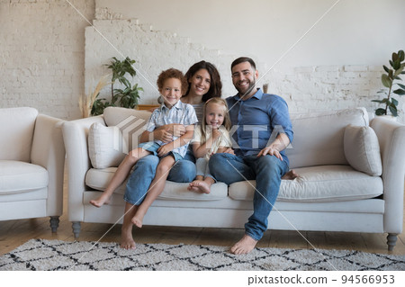Happy well-being homeowners family pose on camera at home 94566953