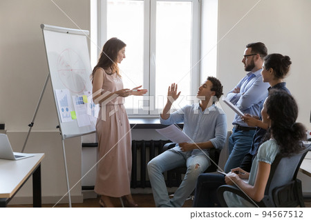 Business teacher woman giving presentation to diverse interns 94567512