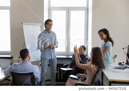 Employee asking question to presenter on corporate meeting Employee asking question to presenter on corporate meeting 94567539