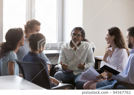 Indian man speaking on group therapy meeting, sharing story Indian man speaking on group therapy meeting, sharing story 94567762