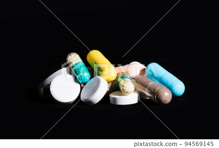Heap of assorted pharmaceutical medicine pills in tablets and capsules different colors, medication 94569145