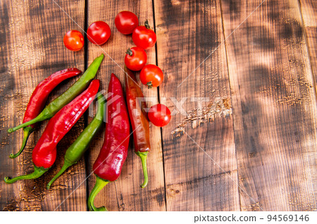 Feel the piquancy. Chili peppers and cherry tomatoes. Red and green vegetables. Organic vegetables Feel the piquancy. Chili peppers and cherry tomatoes. Red and green vegetables. Organic vegetables 94569146