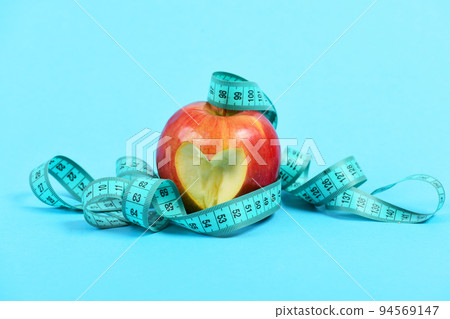 Tape for measurement in cyan blue color with juicy apple Tape for measurement in cyan blue color with juicy apple 94569147