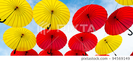 Red and yellow umbrellas hanging sky background bottom-up Red and yellow umbrellas hanging sky background bottom-up 94569149