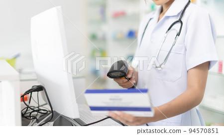 Pharmacist or cashier scanning medicinal products at checkout, Pharmacist or cashier is charging a customer for a drug order, Hold the barcode scanner to pay, Pharmacists work in a pharmacy. Pharmacist or cashier scanning medicinal products at checkout, Pharmacist or cashier is charging a customer for a drug order, Hold the barcode scanner to pay, Pharmacists work in a pharmacy. 94570851