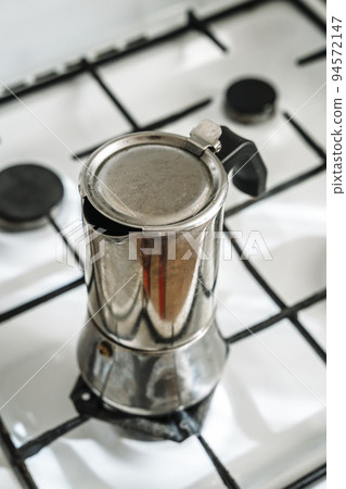 Metal coffee maker for brewing espresso coffee on the stove. Alternative brewing methods Metal coffee maker for brewing espresso coffee on the stove. Alternative brewing methods 94572147