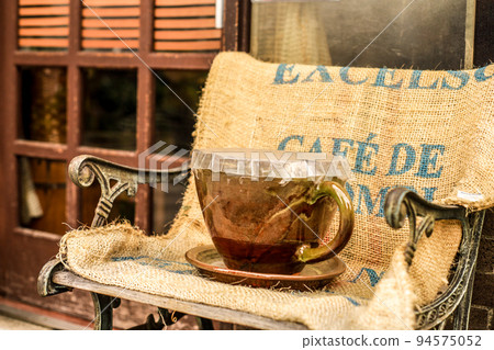 large coffee cup on chair large coffee cup on chair 94575052