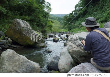 Men doing fly fishing Men doing fly fishing 94575150