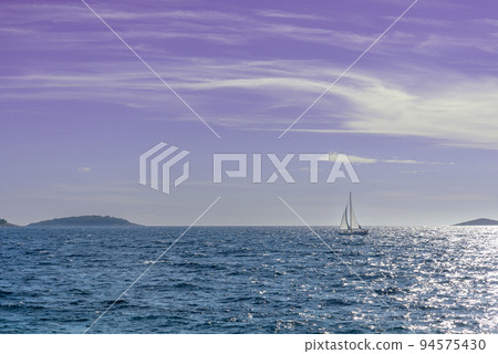 Lonely white sail on the sea. Lonely white sail on the sea. 94575430