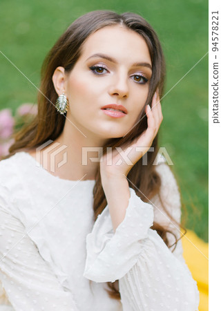 fresh feminine clean facial skin and light nude makeup looks at the camera 94578221