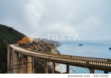 Bridge over cliffs and ocean 94578309