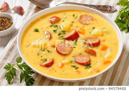 German potato soup with sausages in bowl 94579488