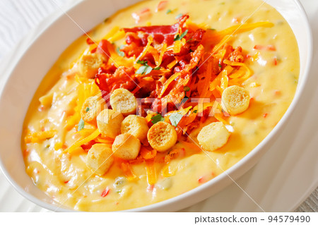 savory creamy pumpkin soup in bowl, top view 94579490