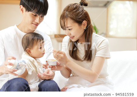 Baby eating baby food Baby eating baby food 94581559