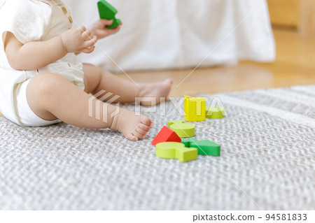 Baby playing with building blocks 94581833
