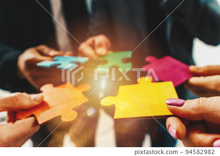 Teamwork of partners connect puzzle pieces as integration and startup 94582982