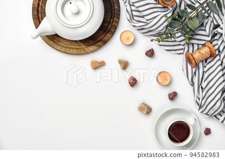 Opened diary with pen on the table near hot cup of black tea 94582983