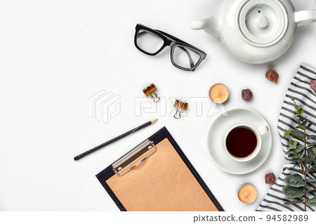 Opened diary with pen on the table near hot cup of black tea Opened diary with pen on the table near hot cup of black tea 94582989