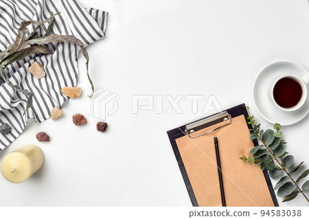 Blank opened notebook with cup of coffee on white table. Top view. Writing concept 94583038