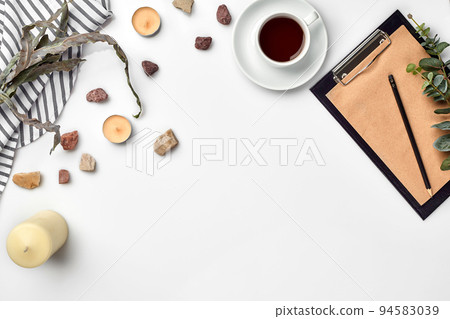 Blank opened notebook with cup of coffee on white table. Top view. Writing concept 94583039