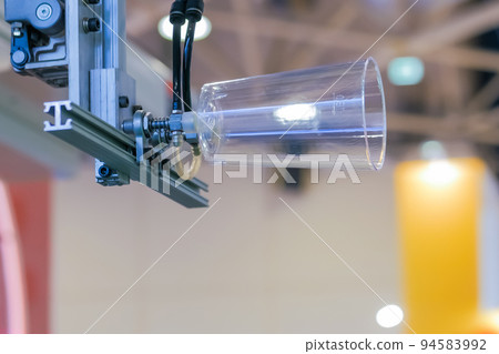 Automatic robotic arm manipulator with suction cups moves plastic cup Automatic robotic arm manipulator with suction cups moves plastic cup 94583992