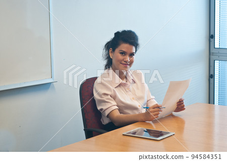 Business woman examining contract agreement in office 94584351