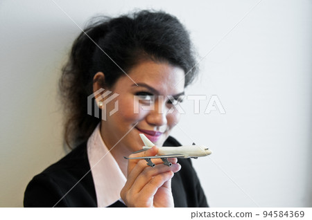 Business woman hold plane model toy on hand Business woman hold plane model toy on hand 94584369