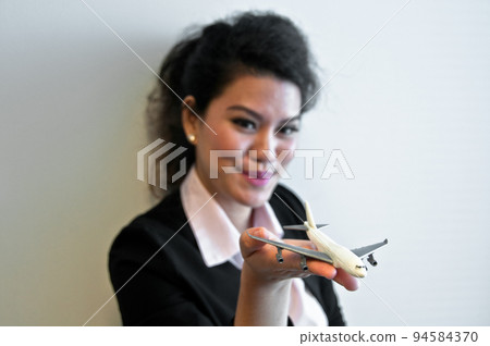 Business woman hold plane model toy on hand 94584370