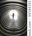 An innocent child running through a tunnel to his mother beyond the light 94584391