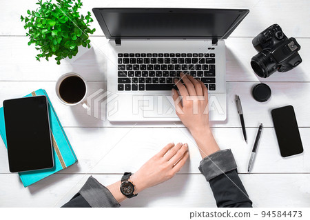 Overhead view of businesswoman working at computer in office Overhead view of businesswoman working at computer in office 94584473