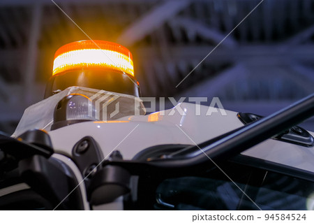 Close up of warning orange beacon flashing Close up of warning orange beacon flashing 94584524