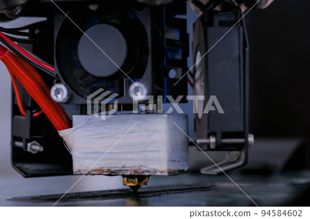 3D printing machine printing plastic model - close up view 94584602